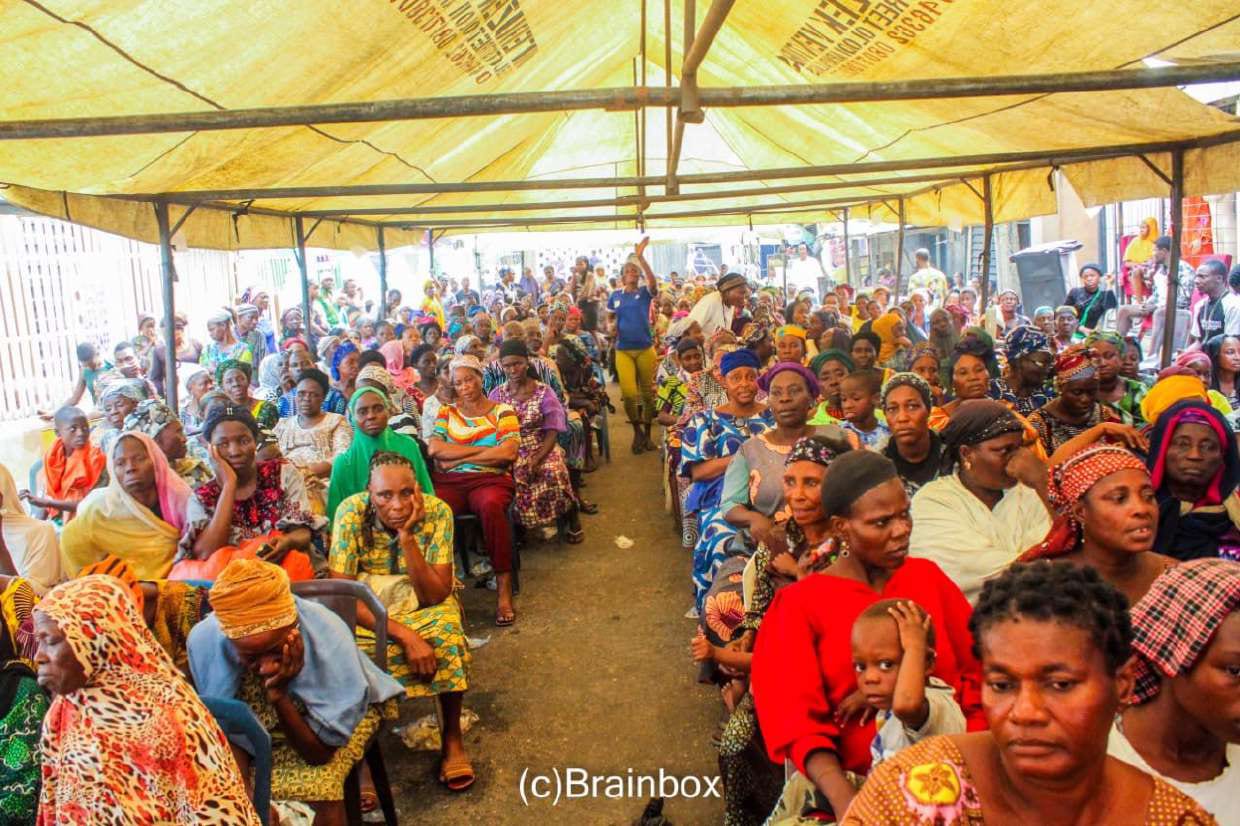 Hundreds of women seated under the canopy at the December 2025 outreach