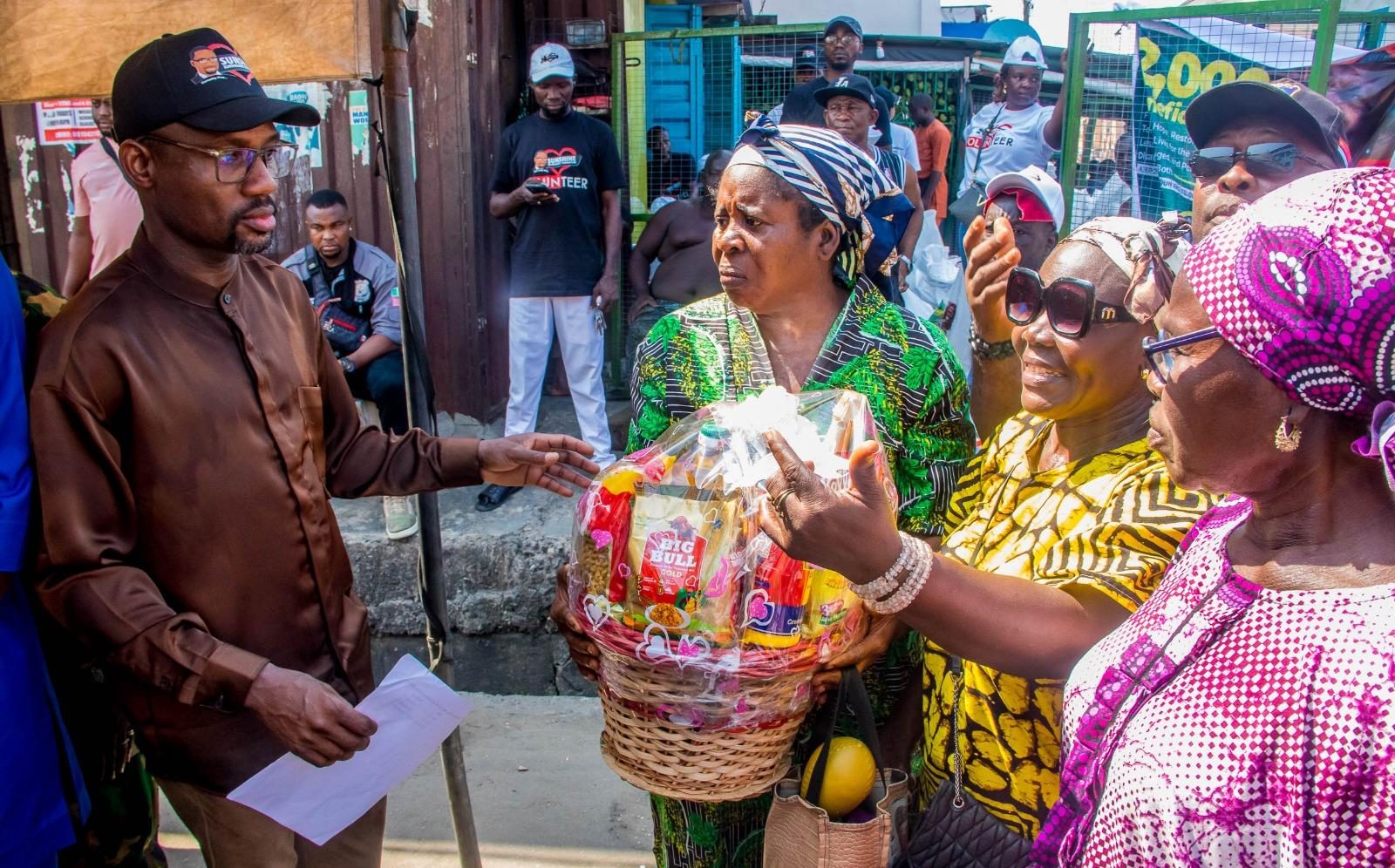 An elderly woman receives a food basket