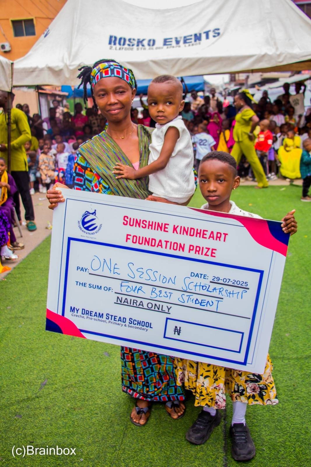 A girl holds a foundation prize placard